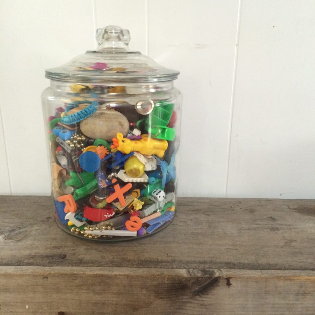 Glass Apothecary Jar filled with small toys 